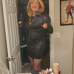 Black leather mini-dress, matching gloves and purse